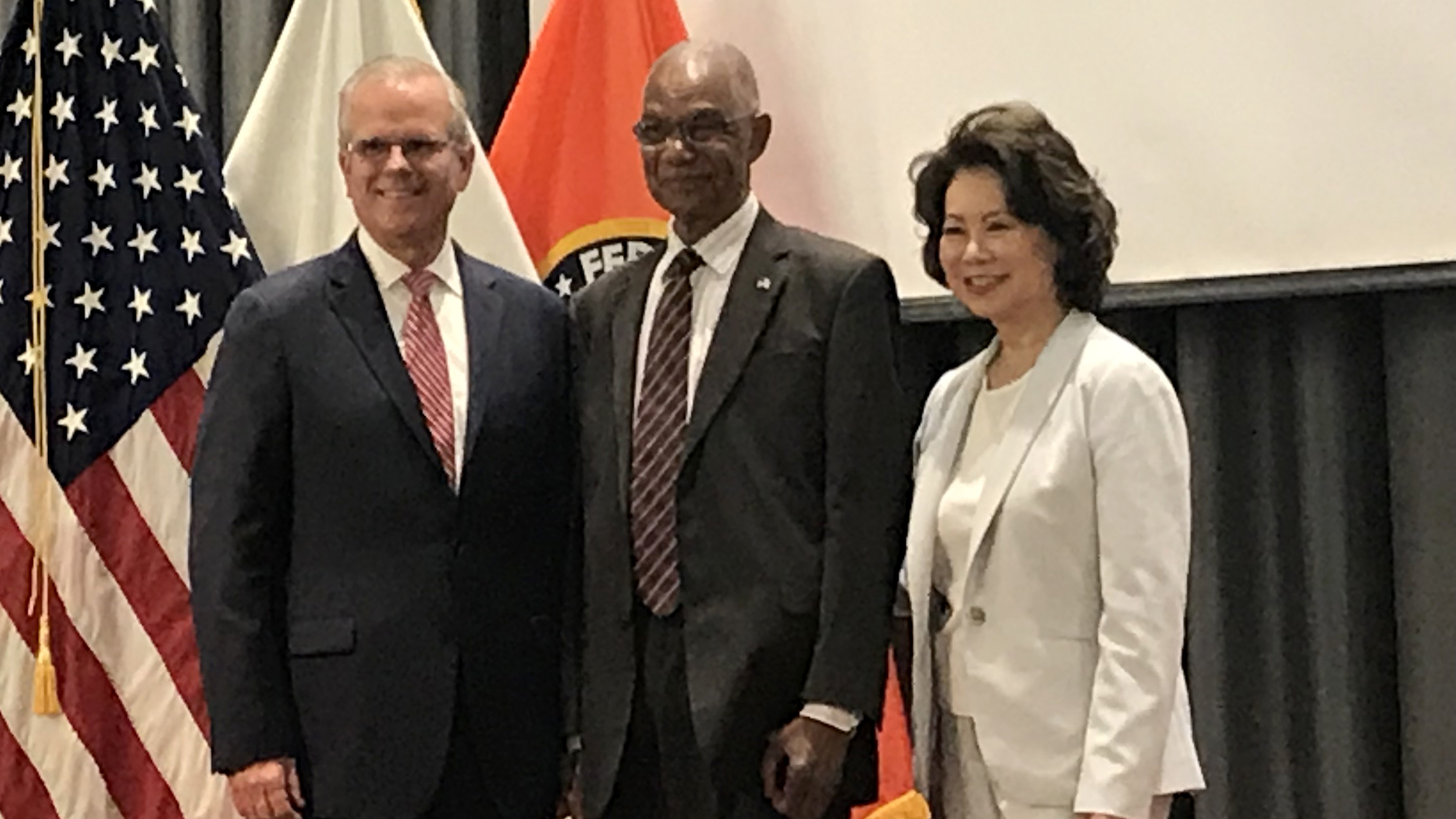 Acting FAA Administrator Daniel Elwell (left) and U.S. Secretary of Transportation Elaine Chao (right) honor Alphonso Barr for 61 years of service at the FAA. Photo by Richard McSpadden.