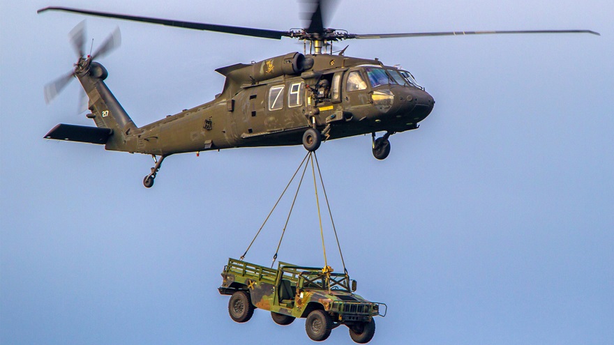 A U.S. Army UH-60 Black Hawk helicopter transports a Humvee via slingload during air assault training at Joint Base Lewis-McChord, Washington, April 27, 2016. U.S. Army photo by Capt. Brian Harris.