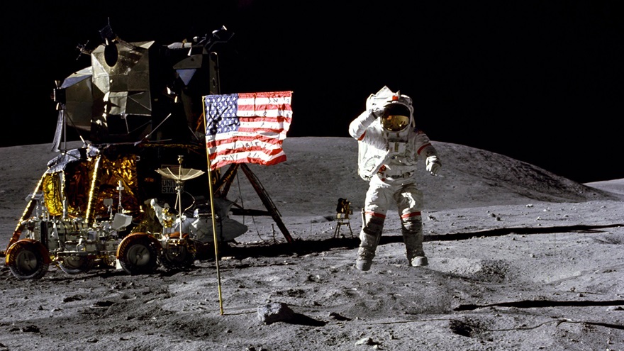 John Young walks on the moon in front of the Lunar Module and Lunar Rover. Photo courtesy of NASA.