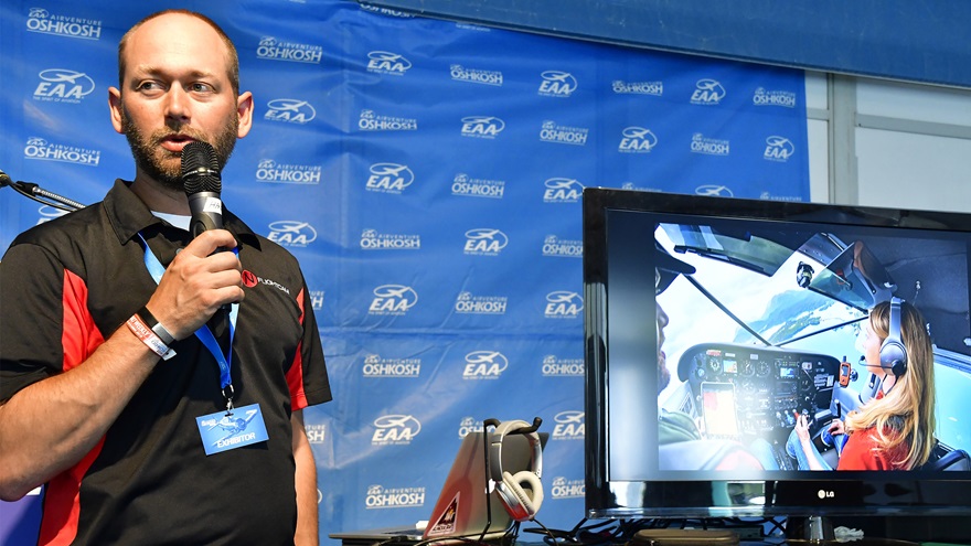 Nflightcam founder Patrick Carter describes his company's newest product, the NflightMic Nomad, which transforms consumer headsets into aviation headsets, during EAA AirVenture in Oshkosh, Wisconsin, July 25, 2018. Photo by David Tulis.