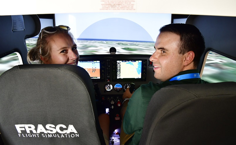 Utah Valley University students practice on a Frasca simulator during the company's sixtieth anniversary celebration luncheon at EAA AirVenture in Oshkosh, Wisconsin, July 25. Photo by David Tulis.