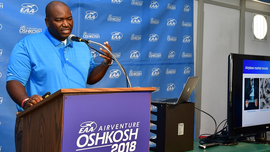 Boeing jobs forecaster William Ampofo releases the annual Pilot and Technician Outlook during EAA AirVenture at Wittman Regional Airport in Oshkosh, Wisconsin, July 23, 2018. Photo by David Tulis.