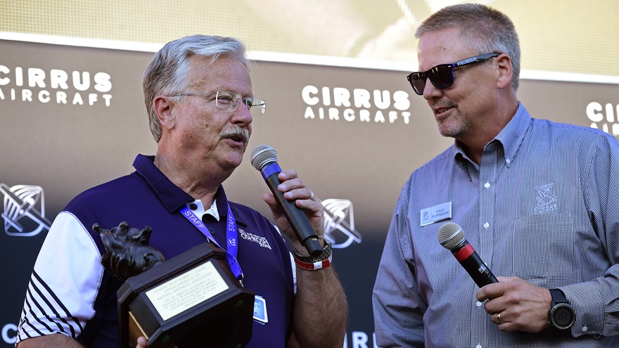 EAA President Jack Pelton, left, holds a replica of the Collier Award presented to him by 2018 Collier Award winner and Cirrus Aircraft co-founder Dale Klapmeier during a pilot social at EAA AirVenture in Oshkosh, Wisconsin, July 22, 2018. Pelton said the replica trophy will be on display at EAA's museum. Photo by David Tulis.