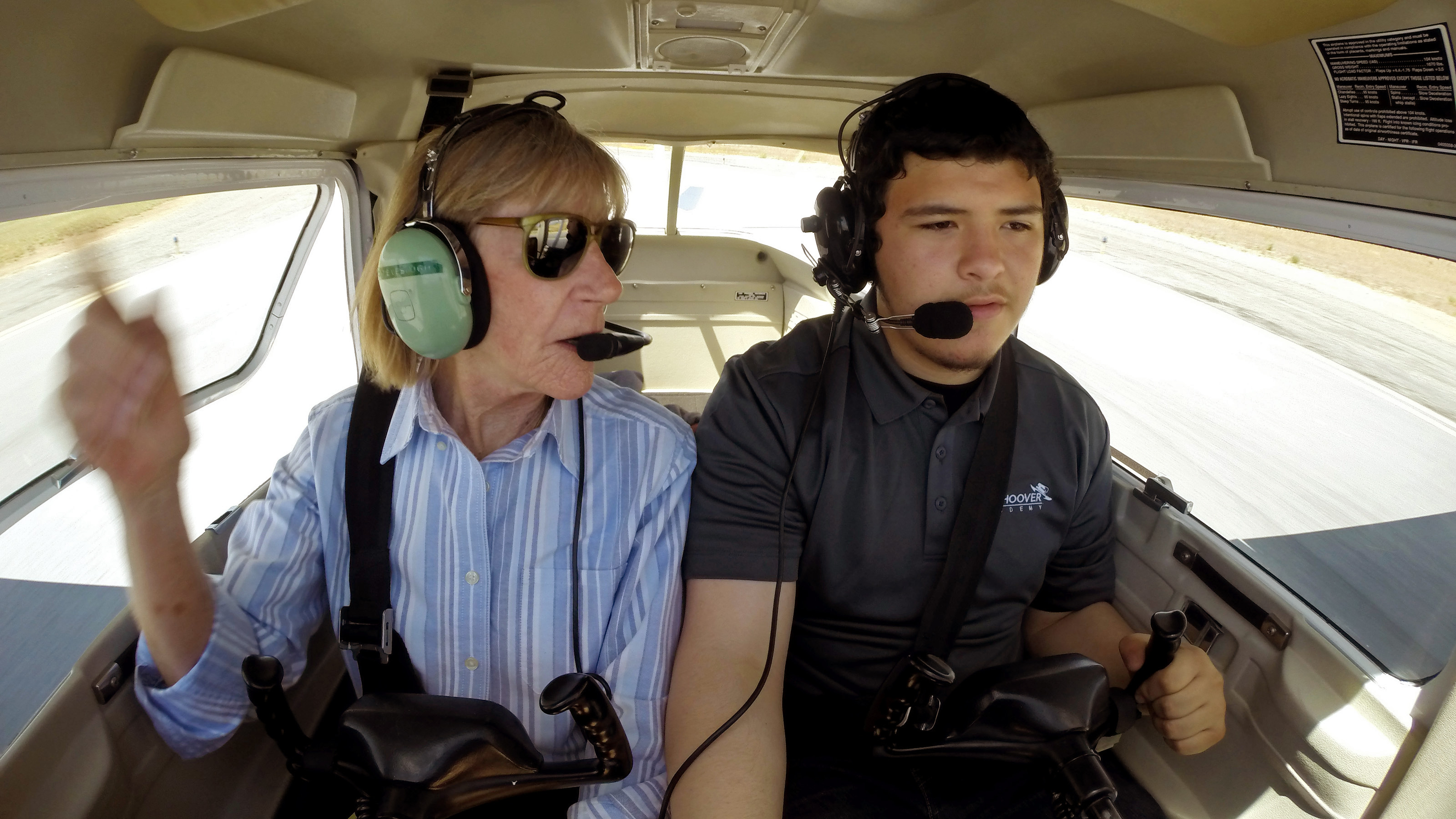 Bob Hoover Academy flight instructor, den mother, drill sergeant, and cheerleader Carol Tevebaugh watches student Edgar Villalobos taxi to the runway for a flight at Salinas Municipal Airport, May 11, 2018. Photo by David Tulis.