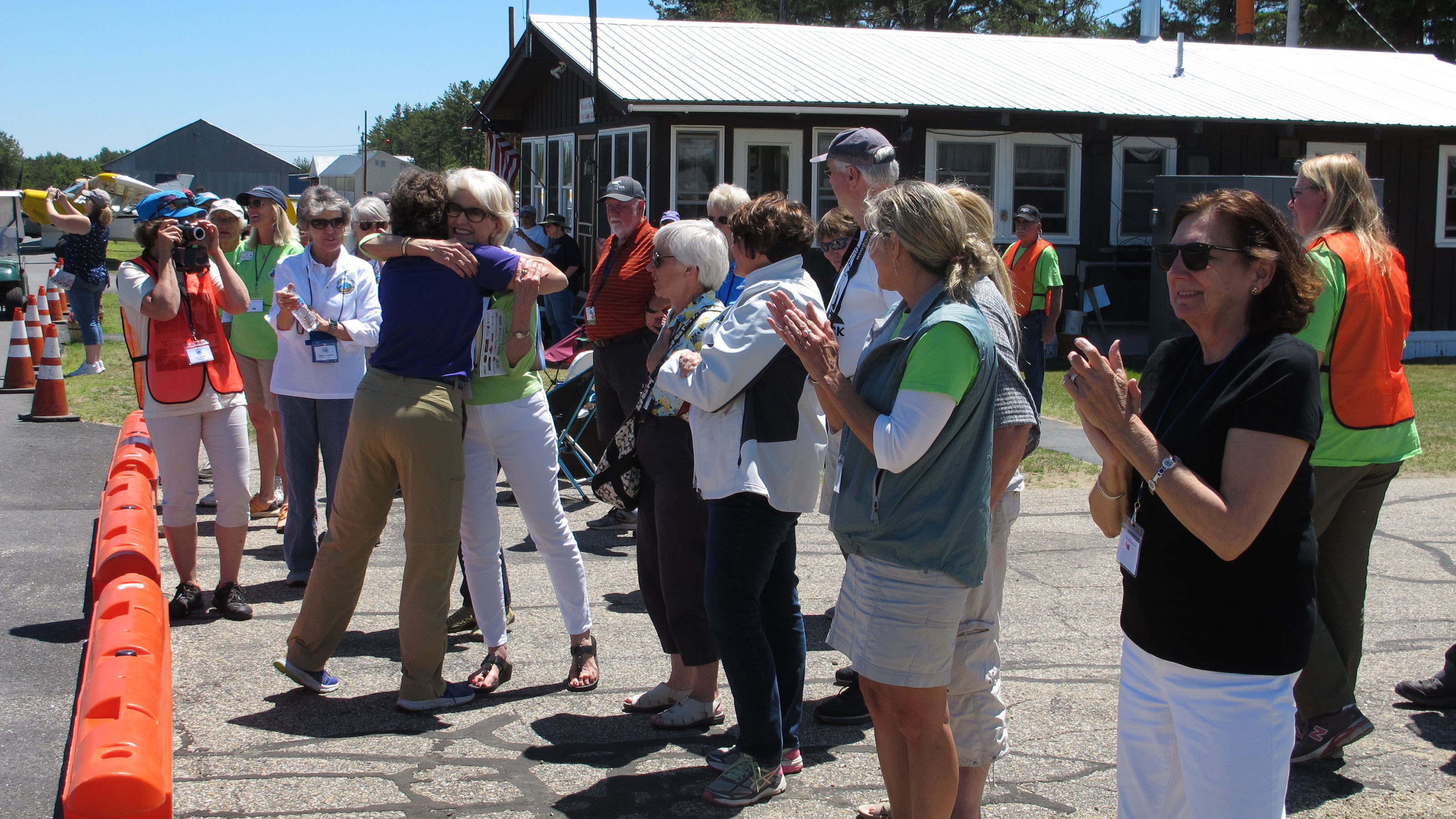 Teresa Camp gets a hug from a supporter after completing the Air Race Classic. Photo by Dan Namowitz.