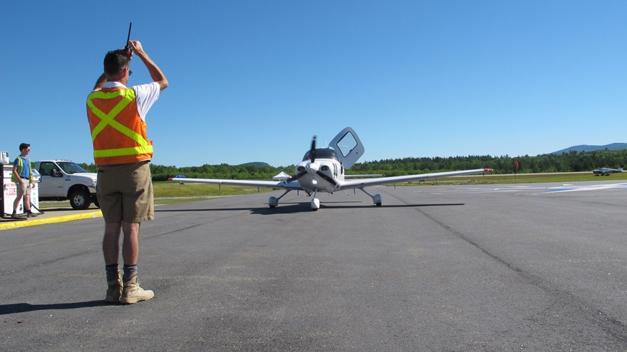Eastern Slope Regional Airport manager Dave Cullinan parks a racer during a busy two days of arrivals as the 2018 Air Race Classic was winding up in Fryeburg, Maine. Photo by Dan Namowitz.