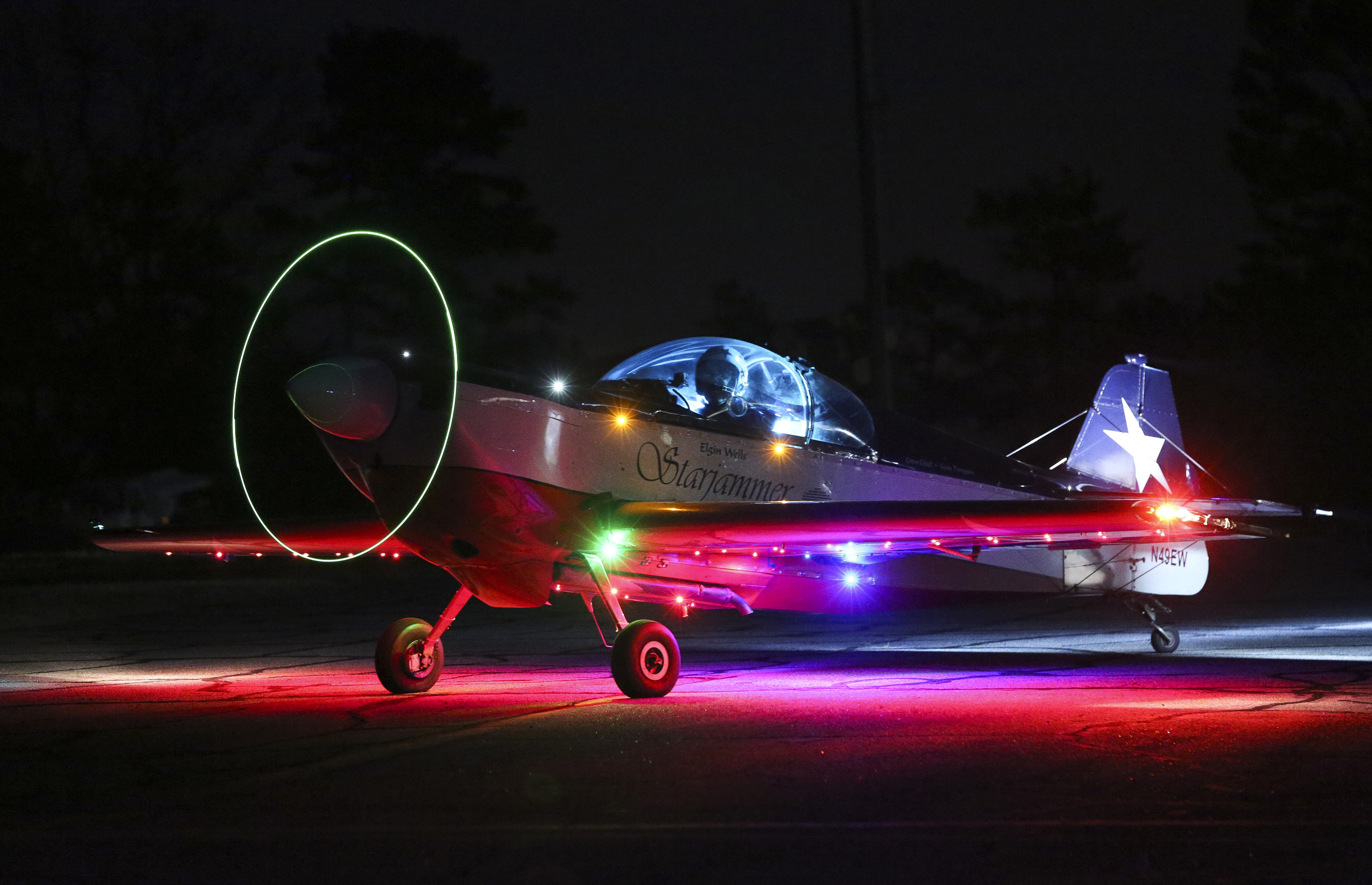 Elgin Wells performs a nighttime demonstration in his  aerobatic plane 'Starjammer' at Cherokee County Airport in this 2014 file photo in Ballground, Georgia. The One Design kit airplane is equipped with hundreds of LEDs in order to provide the glow for his night performances. Photo courtesy of the Gwinnett Daily Post.