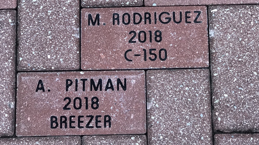 The Central Florida Aerospace Academy celebrates first solos by placing red clay bricks in the walkway that leads to the school’s main entrance. Photo by Jamie Beckett.