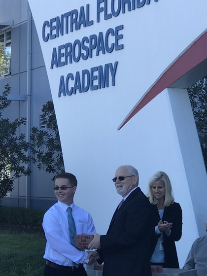 Andrew Pitman is honored by Keith Smith, the outgoing assistant principal of the Central Florida Aerospace Academy, for his first solo. Photo by Jamie Beckett.