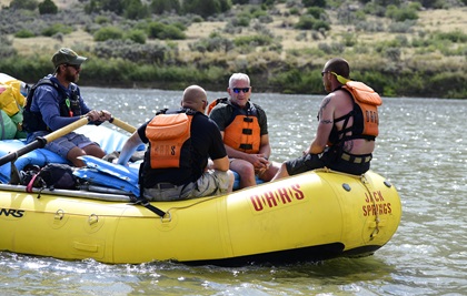 OARS guide Sean Sorrin paddles military veterans Michael Hall, Bill Johnson, and Mike Dante on the Green River near Vernal, Utah, in Dinosaur National Monument park. Photo by David Tulis.