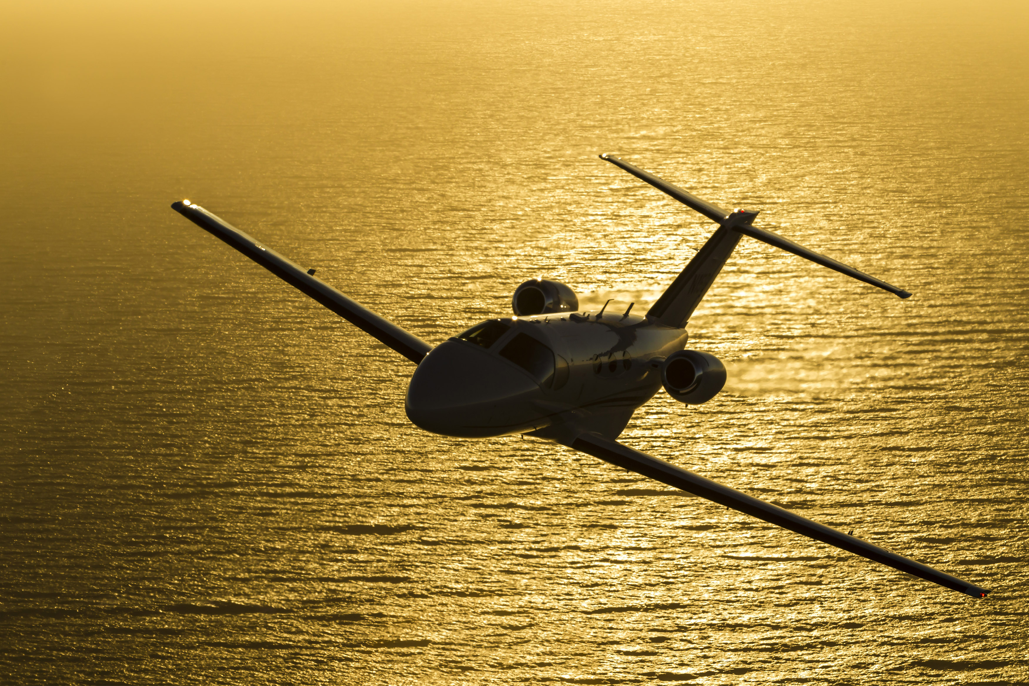 A Cessna Mustang light jet flies near the California coast. Photo by Mike Fizer.