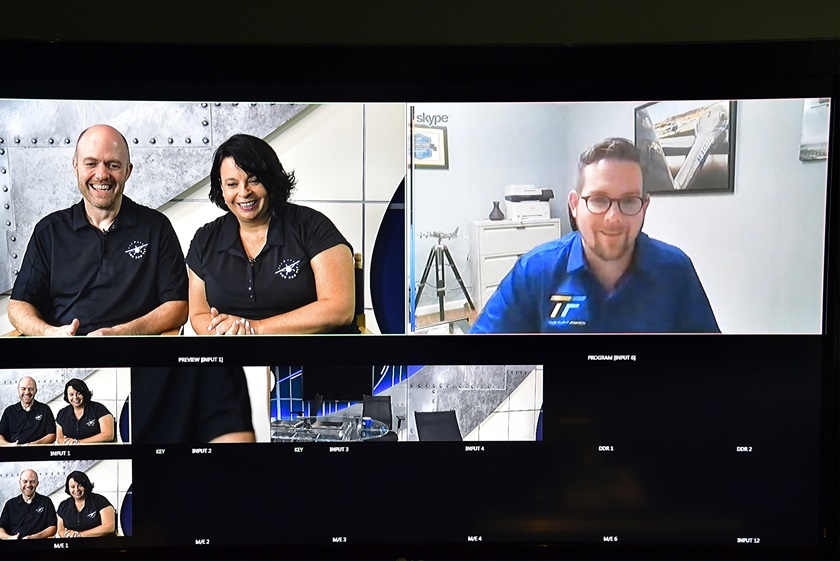 Ryan Mayo of Take Flight Aviation in New York learns from AOPA You Can Fly staff members Chris Moser and Elizabeth Tennyson that the flight school was voted by students as the best in the nation, during the AOPA 2018 Flight Training Experience Awards, Oct. 10, 2018. Photo by David Tulis.