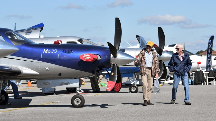 Two visitors to the AOPA 2018 Gulf Shores, Alabama, Fly-In look at a Piper M600 turboprop in the aircraft static display. Photo by Mike Collins.