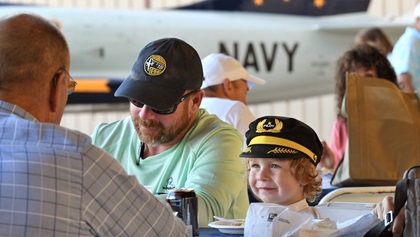 Amundsen Schmitz, 4, at right, sits next to his father, Arlan Schmitz, during the pancake breakfast at the AOPA Santa Fe Fly-In. They flew to their first AOPA Fly-In from Portales, New Mexico, in their Cessna 185. Photo by Mike Collins.