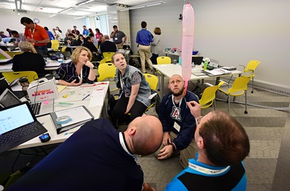High school educators participate in a hands-on rocket-launch workshop at the AOPA You Can Fly Academy that will help them teach the AOPA ninth grade curriculum to students. They were tasked with attaching a payload of paper clips to balloons to study payload and thrust. Photo by David Tulis.