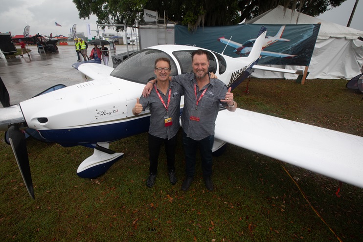 Jean d'Assonville, left, and Wayne Toddun celebrated a safe arrival in Florida in time for Sun 'n Fun, enduring a little more rain on April 1. The Sling TSi they flew from California is behind them. Photo by Jim Moore.