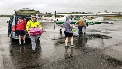 Pacific Northwest volunteers load cargo into a single-engine Cessna during an earthquake disaster preparedness drill. Photo courtesy of Sky Terry.