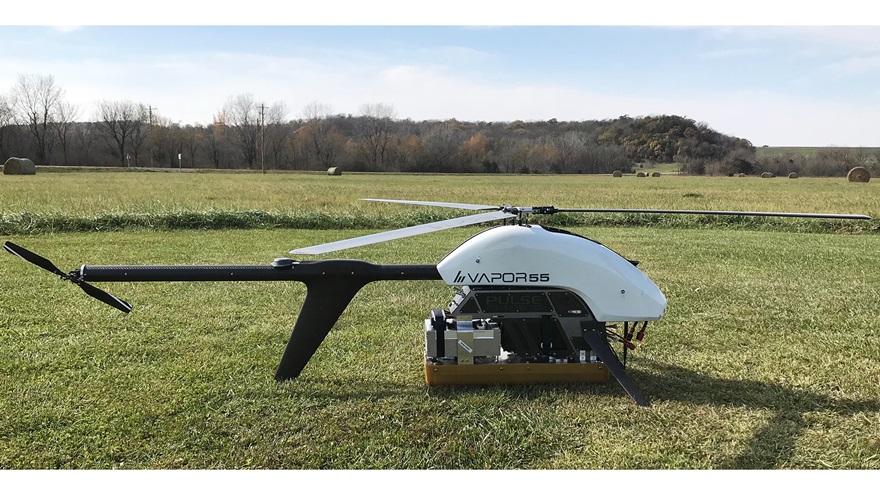 The AeroVironment Vapor 55 UAS helicopter with the 2-18 GHz radar (high-frequency radar) prototype. The radar will be used to measure surface features, particularly crevasse size and shape. The silver box is the radar, and the tan ÒboxÓ below is the antenna. Photo courtesy of Emily Arnold.