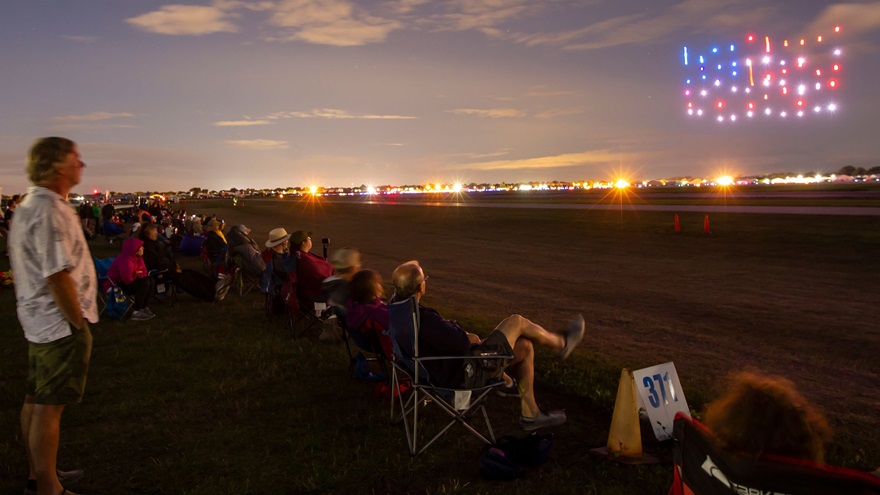 EAA AirVenture attendees watch the 2018 drone show in Oshkosh, Wisconsin. The same crew will create displays at all three AOPA Fly-Ins in 2019. Photo courtesy of Great Lakes Drone Company.