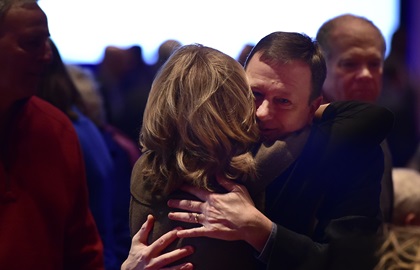 Passengers and family members greet during a 10-year anniversary celebration of US Airways Flight 1549 when Captain Chesley Sullenberger III and First Officer Jeff Skiles expertly glided a damaged Airbus A320 to safety on the Hudson River in New York on Jan. 15, 2009. Photo by David Tulis.