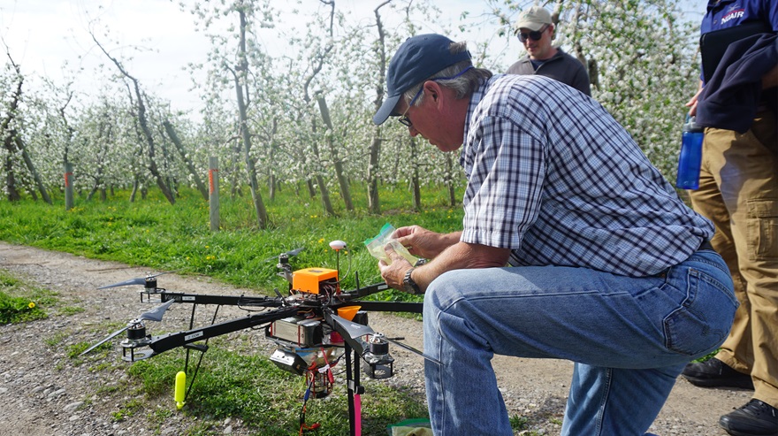 Dropcopter CEO Matt Koball loads pollen into one of the firm's hexacopters. Photo by Kevin Foresti courtesy of Dropcopter.