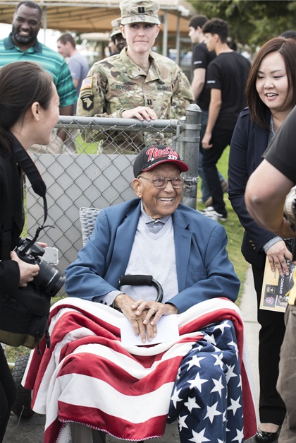 Retired Lt. Col. Robert Friend jokes with international media members during Army Recruiting Command's outreach event in Perris, California, where he swore in new Army recruits. U.S. Army photo by Joe Lacdan.