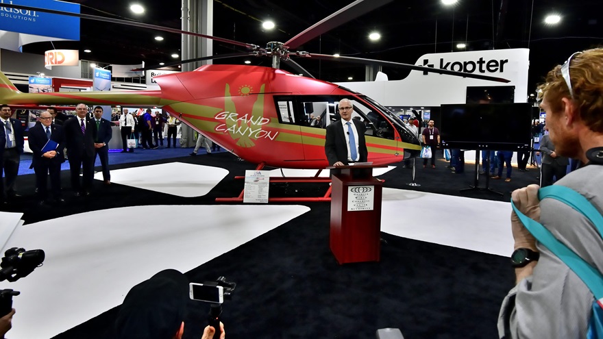 With a Kopter SH09 in the background, Andreas Löwenstein, Kopter Group chief executive officer, announces that the helicopter will be built in Lafayette, Louisiana. He expects U.S. customers will account for more than half of annual production. Photo by Mike Collins.