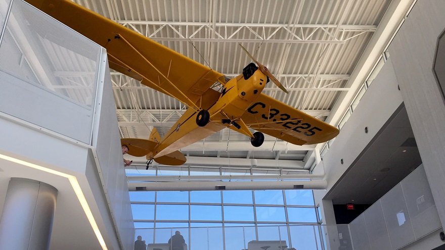 A Piper Cub hangs from the ceiling of the new terminal and education center at Ohio State University Airport, which houses an education center and an observation area where students and guests can watch takeoffs and landings. Photo by Kyle Lewis.