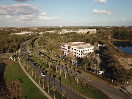 Aerial view of street, office buildings and sunny sky.