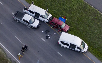 Officials investigate near a red vehicle believed to be that of the Austin bombing suspect Mark Conditt on I-35 in Round Rock on Wednesday March 21, 2018. Photo by Jay Janner/Austin American-Statesman used with permission.