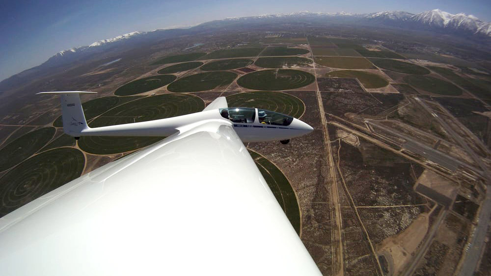 Climbing in a steep turn without an engine? That's called "thermaling." This sleek high-performance fiberglass sailplane is just off tow and circling to gain altitude above the Minden, Nevada, airport, framed by the snow-capped Sierra Nevada. Photo courtesy of SoaringNV.