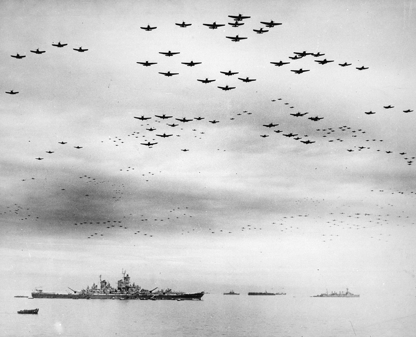 Vought F4U Corsairs and Grumman F6F Hellcats fly in formation past the <em>USS Missouri</em> during surrender ceremonies in Tokyo Bay on Sept. 2, 1945. Photo No. 80-G-421130 courtesy of the National Archives.