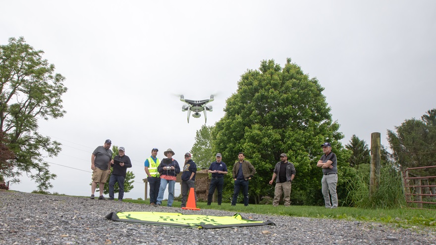 A DARTdrones DJI Phantom 4 lifts off to begin a mapping run on May 11 during a DARTdrones workshop that included classroom and hands-on learning. Photo by Jim Moore.