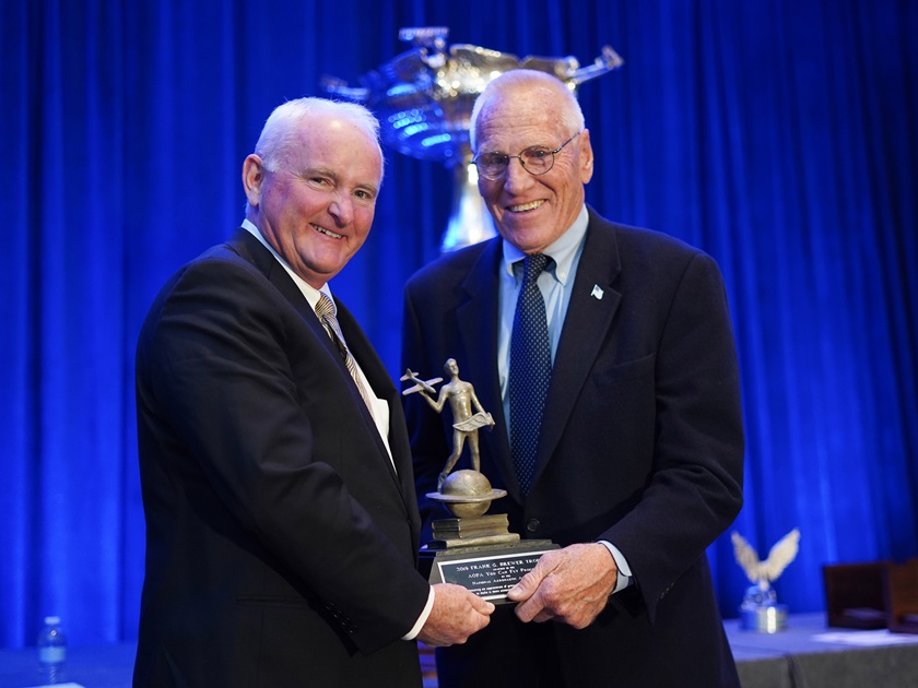 AOPA President Mark Baker, left, accepts the National Aeronautic Association's Frank G. Brewer Trophy on behalf of AOPA's You Can Fly initiative from NAA board member Dick Koenig. Photo courtesy of D.S. Photo.