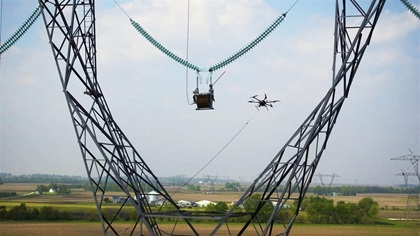 The drone must guide the rope into the orange guide rail and then snap the line through a gate before flying to the next tower. Photo courtesy of SkySkopes.