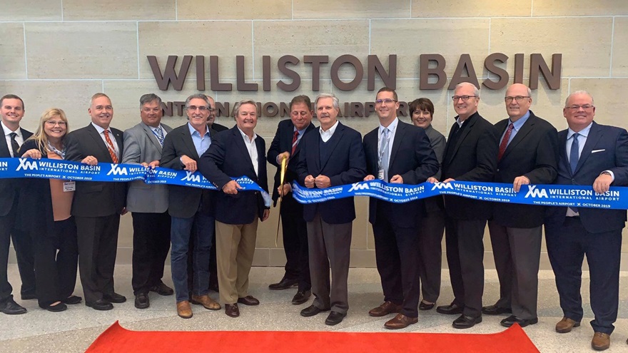 A new airport is open in "Bakken boom" country, where Williston, North Dakota, Mayor Howard Klug cut a ceremonial ribbon to commence operations at Williston Basin International Airport. Officials joining the celebration included (at Klug's right) former Gov. Jack Dalrymple; Gov. Doug Burgum; and (at Klug's left) Sen. John Hoeven. Photo by Kyle Lewis.