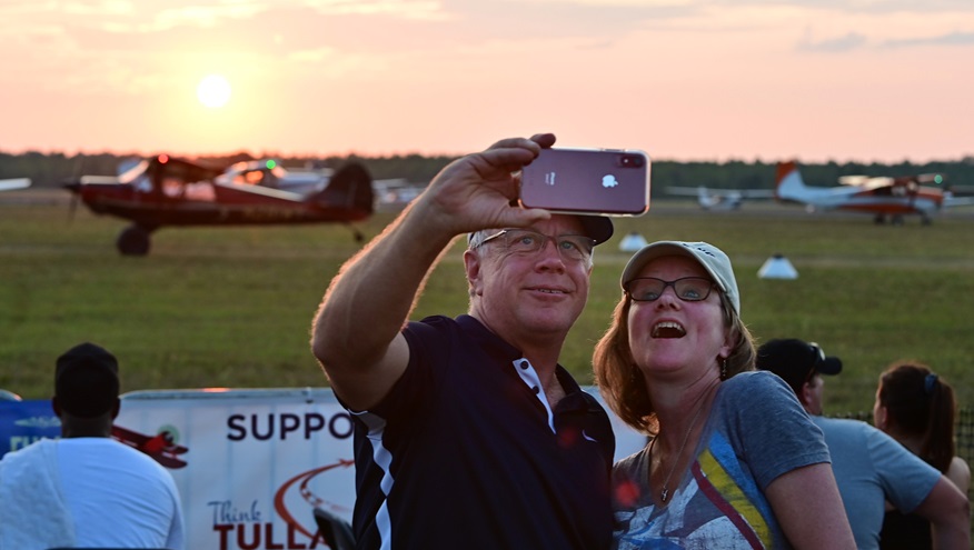 AOPA Tullahoma, Tennessee, Fly-In participants use a phone camera to take a photo during the short takeoff and landing demonstration. Photo by David Tulis.