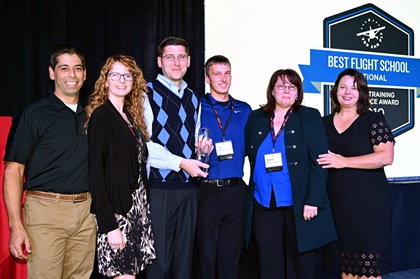 The Allen family from AeroVenture in Massachusetts received the top flight school award during the 2019 AOPA Flight Training Experience Awards at the Wings Over the Rockies museum in Denver, October 16. Photo by David Tulis.