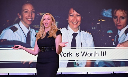 Erika Armstrong, backed by a photo of her all-female flight crew, talks about her experience as an airline pilot during Redbird Migration at the Wings Over the Rockies Air and Space Museum at Centennial Airport in Denver October 16. Photo by David Tulis.