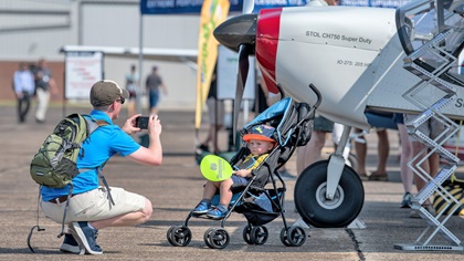 Chris Clawson of Mt. Juliet, Tennessee, photographs his son, Charlie, age 21 months, in the static display at AOPA's Tullahoma Fly-In. Clawson is an air traffic controller in Nashville. Photo by Mike Collins.