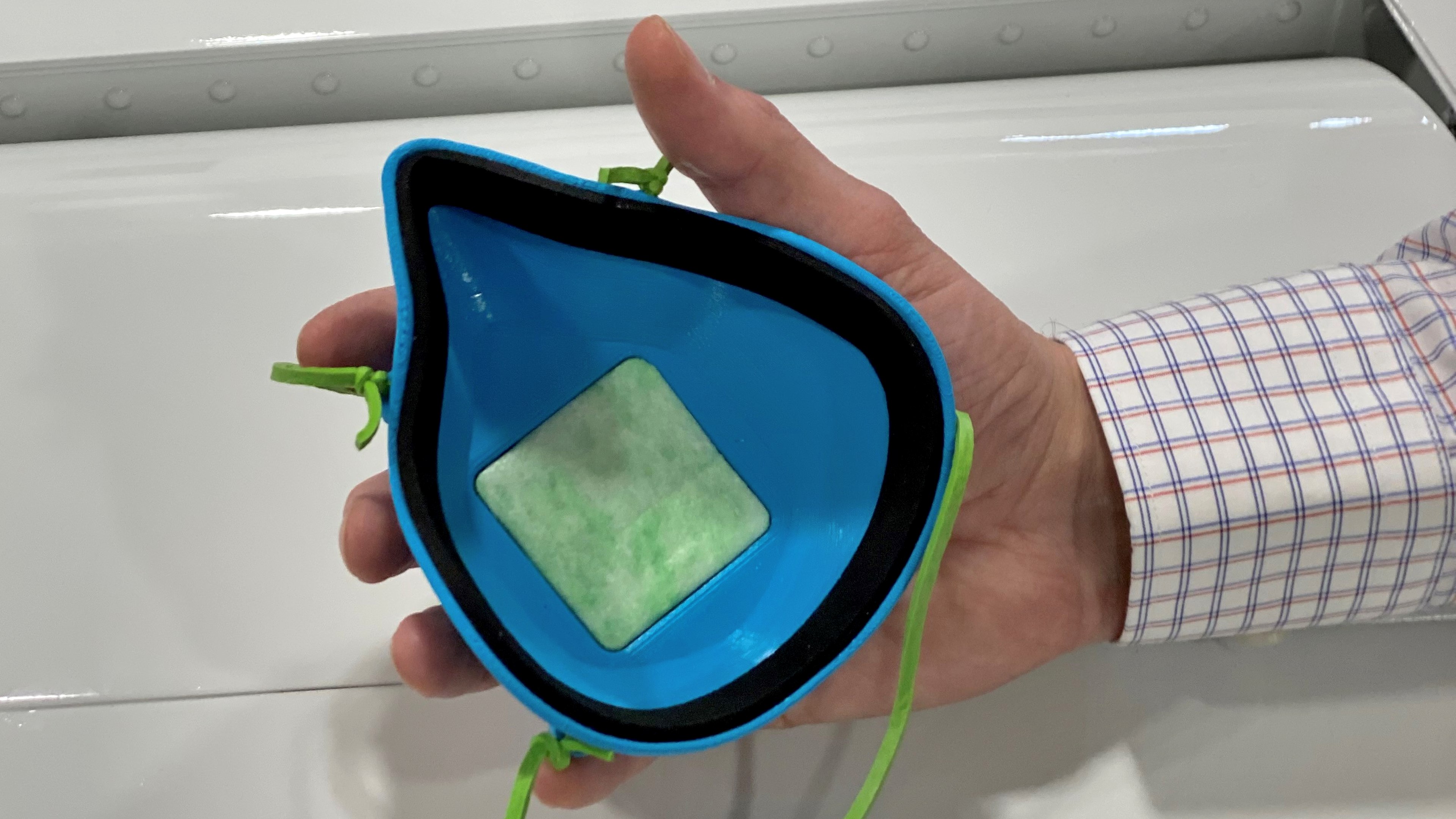 Nathan Cropper, chief engineer for Tamarack Aerospace, holds a 3-D printed, reusable protective face mask the company made for a local hospital. Photo courtesy of Tamarack Aerospace.