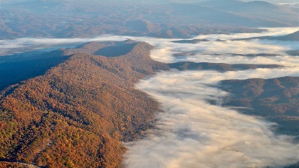 Viewing fall foliage from the air is a spectacular way to take in the beauty of nature. When a little morning fog still lingers in the valleys, it can be quite peaceful to see. Extra caution should be exercised, however, to be certain that ample emergency landing options are available and identified before flying over the low-lying overcast. Photo by Chris Eads.