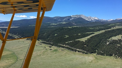 One might not think of a classic Piper Cub as the ideal platform for high-elevation flying in the Rocky Mountains. But with enough preparation for long and slow climbs, and careful choosing of routes through passes and valleys, the “low and slow” nature of the Cub makes for a unique experience. Photo by Chris Eads.
