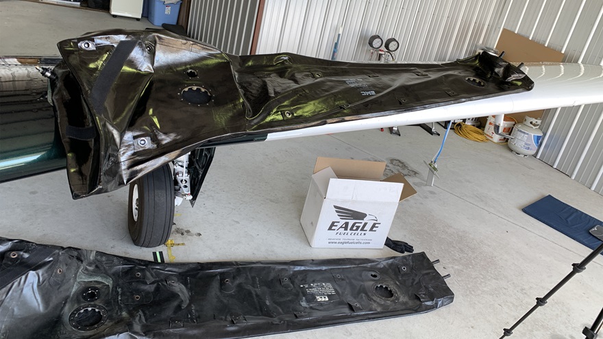 The new fuel cell from Eagle is on top of the wing with the old cell on the floor for reference. Photo courtesy of Jeff Simon.
