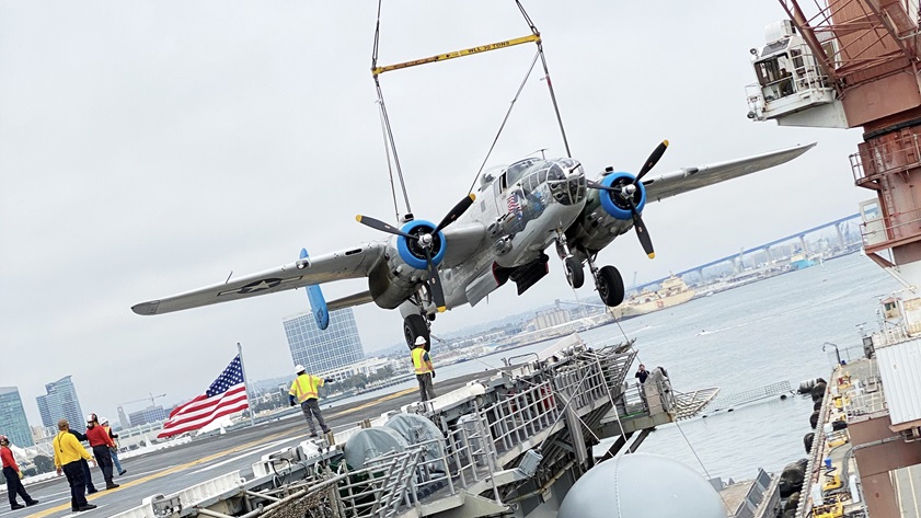 The B-25 "Old Glory" is loaded onto an amphibious assault ship "USS Essex" by crane for transport to Hawaii to participate in an aerial parade commemorating the seventy-fifth anniversary of the end of World War II. Photo courtesy of the Prescott Foundation.