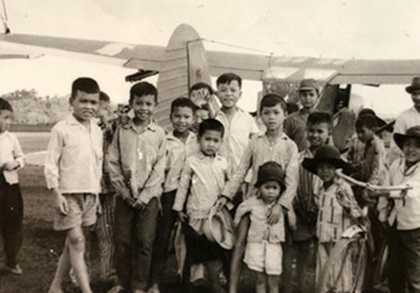 Ron Allen gave rides to Southeast Asia youth during breaks from his missions in a Cessna O-1E Bird Dog airplane when he served in the Vietnam War. The photo of youth surrounding the single-engine liaison and observation aircraft was taken in 1966 at Bao Loc, Lam Dong Province, Republic of Vietnam. Allen said he "would fold down the rear rudder pedals, remove the stick and strap them in, sometimes four at a time. It was great fun, and a nice break from being shot at." Photo courtesy of Ron Allen.