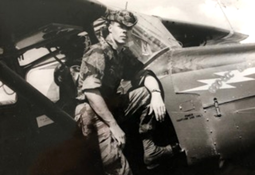 A 22-year-old Ron Allen poses during the Vietnam War on the strut of a Cessna 0-1E Bird Dog which was named the 'Bao Loc Bad Guy.' Photo courtesy of Ron Allen.