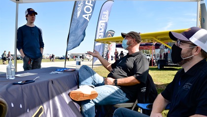 AOPA You Can Fly Florida Ambassador Jamie Beckett (center) and AOPA Senior Manager of Aviation Event Operations Phillip Johnson (right) enjoy a conversation with local CFI Eric Eiermann (left) at the AOPA exhibit tent. Eiermann works with the Aspiring Aviators Aero Club in Winter Haven, Florida, a club that supports AOPA STEM curriculum students at Winter Haven High School. Photo by Chris Eads.