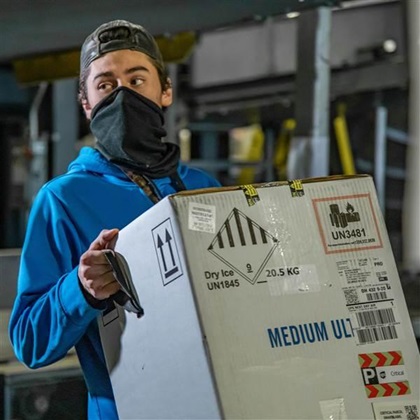 Shipping boxes packed with dry ice to keep the vaccine at the required temperature during transit received special handling at each step. Photo courtesy of UPS Inc.