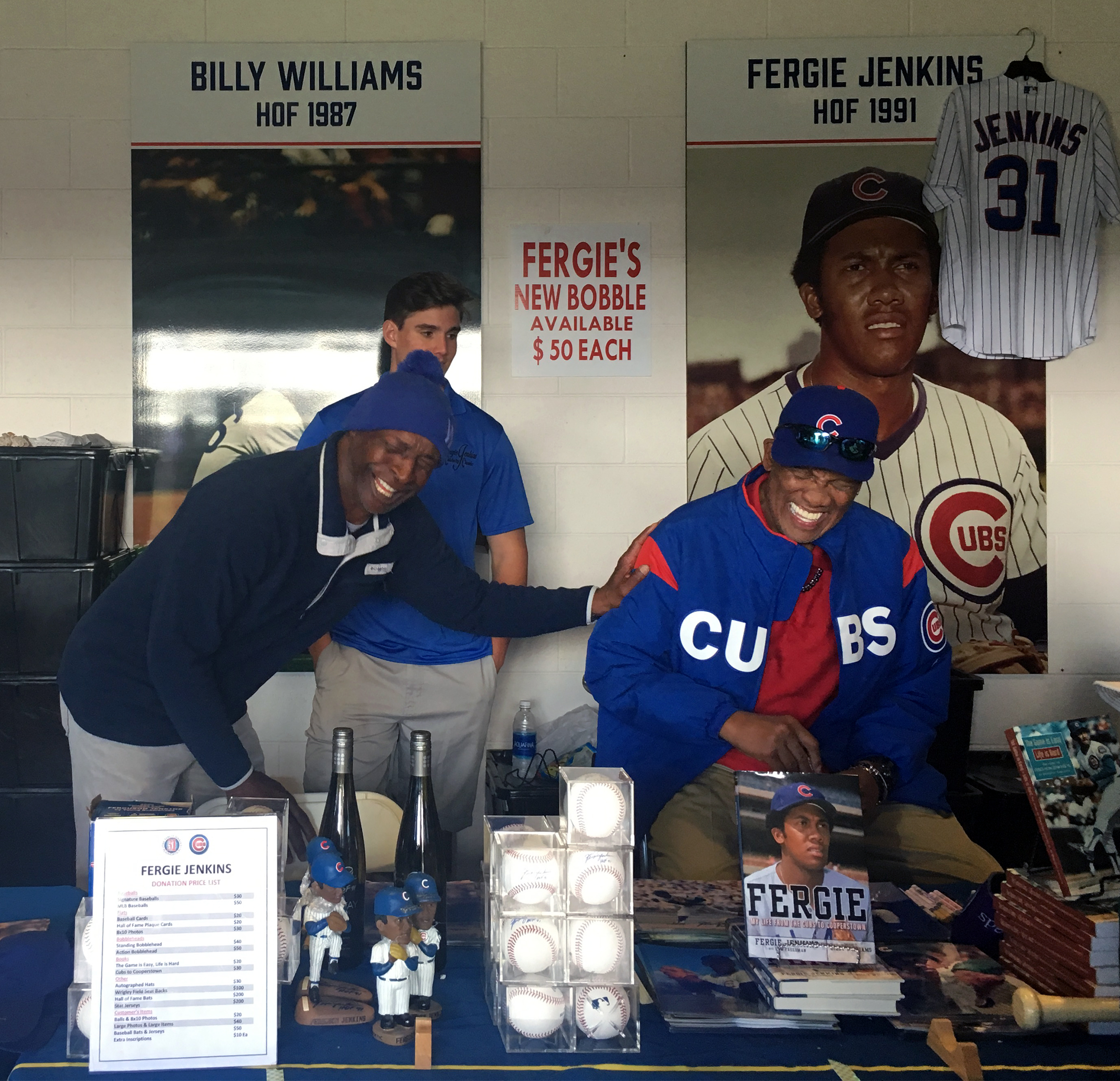 Beyond seeing a game during spring training, fans have a chance to interact with current and former players. Chicago Cubs great and Baseball Hall of Famer Fergie Jenkins, right, and Kansas City Royals fan favorite Willie Wilson share a laugh during an autograph session at Sloan Park in Mesa. Photo by MeLinda Schnyder.